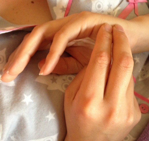Donna demonstrates the set up. She uses two fingers to "tap" on the side of her other hand, below her pinkie finger.