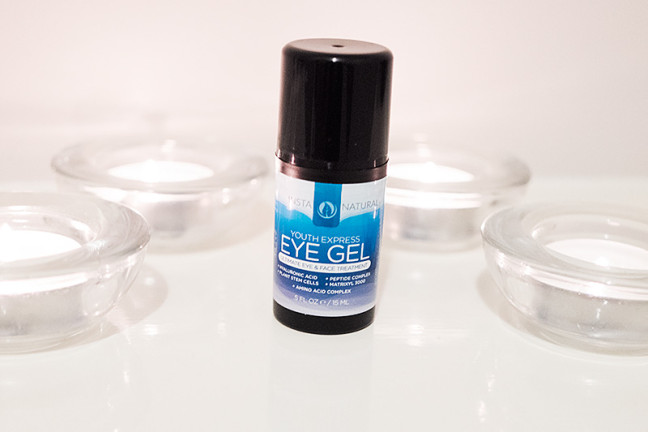 Photo shows the InstaNatural Express Youth Eye Gel on a white shelf surrounded by tealight candles.