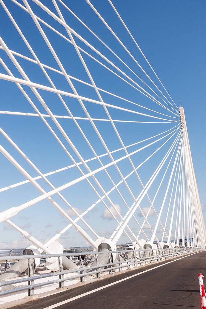 Photograph shows a wide angle view of one of the bridge supports and crossing cables on the Queensferry Crossing.