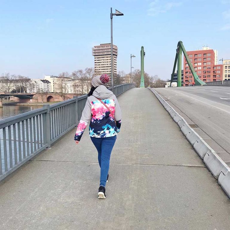 Walking across a bridge in Frankfurt following ACT treatment at Infusio