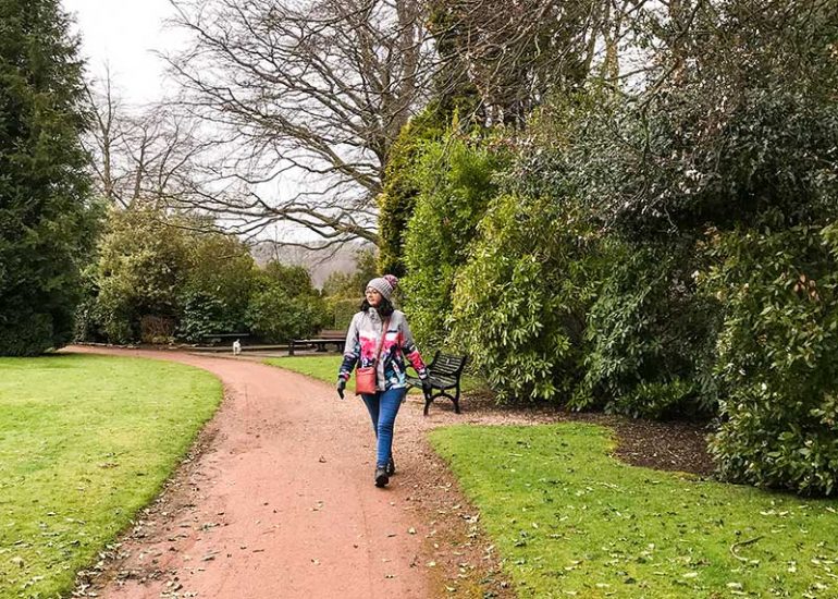 Photo shows Donna walking along a path at a park,