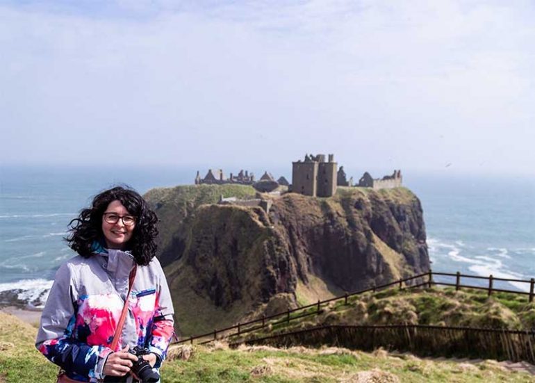 A photograph of me with Dunnottar Castle in the background. Find out how I am doing at six months post stem cells for Lyme Disease, Fibromyalgia and CFS.