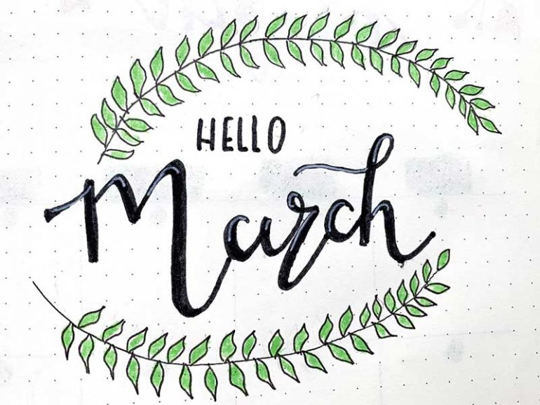 Photo of cover bullet journal page for March. Reads "hello March" framed by leaf doodles