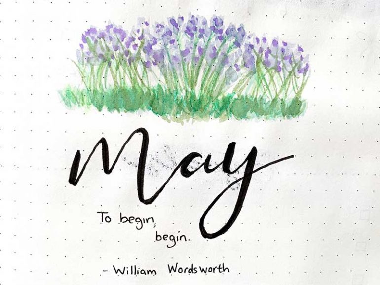 Close up of my May bullet journal cover page. Illustrative bluebells with May written underneath in calligraphy. Under this is a quote that reads "To begin, begin - William Wordsworth"