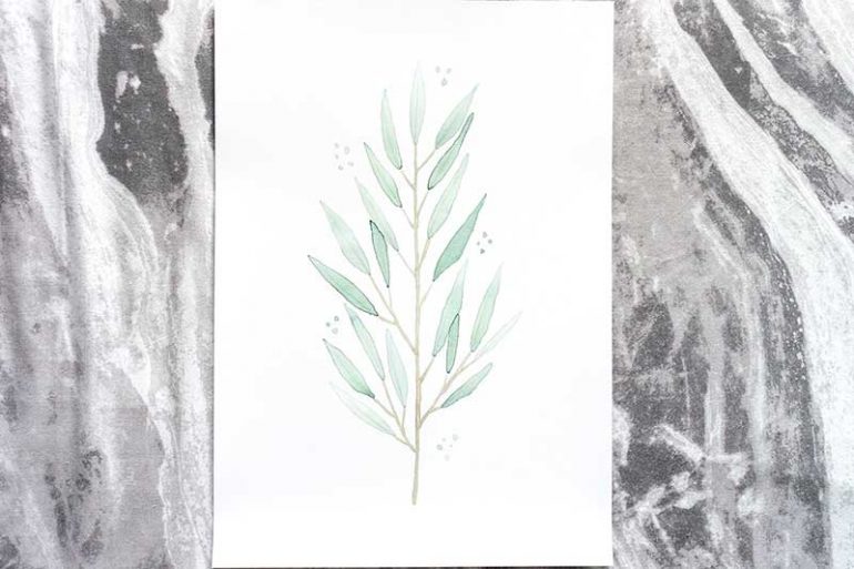 Photo of my eucalyptus nicholii watercolour print taken on a marble background
