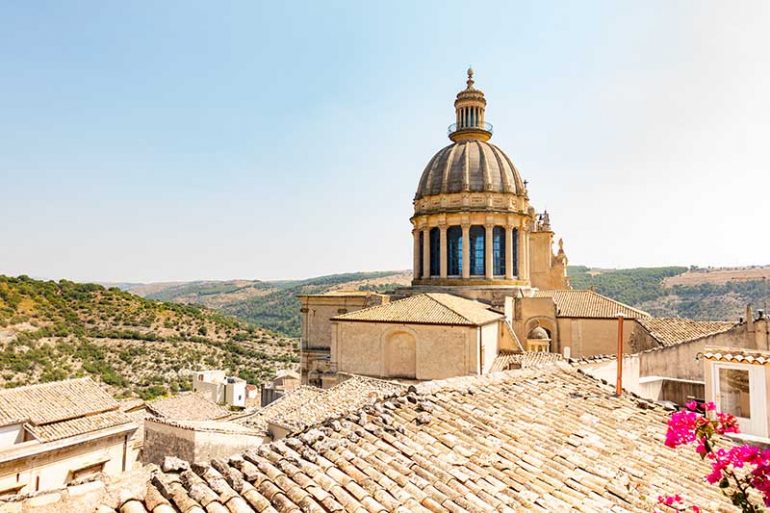 Photo overlooking the rooftops in Ragusa, Sicily. You can see the Dome of Ragusa Ibla’s Cathedral