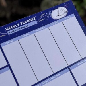 A beautiful weekly planner with blue colour way and a sleeping arctic fox illustration in the corner.