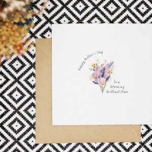 This card features a watercolour bouquet painted in a loose style with pink, purple, red and yellow flowers and green leaves. The card reads Happy Mothers Day to a blooming brilliant Mum in a black handwritten font