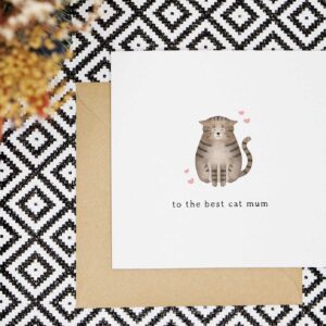 A cute card with a tabby cat sitting with its eyes closed and ears down looking content. There are four pink hearts around the cat and the card reads to the best cat mum.