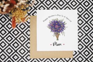 This elegant mother's day card features a hand illustrated bouquet of purple and pink flowers and foliage. It reads Happy Mothers Day to a special Mum. There is a pink love heart on either side of the word Mum. The card can be personalised.